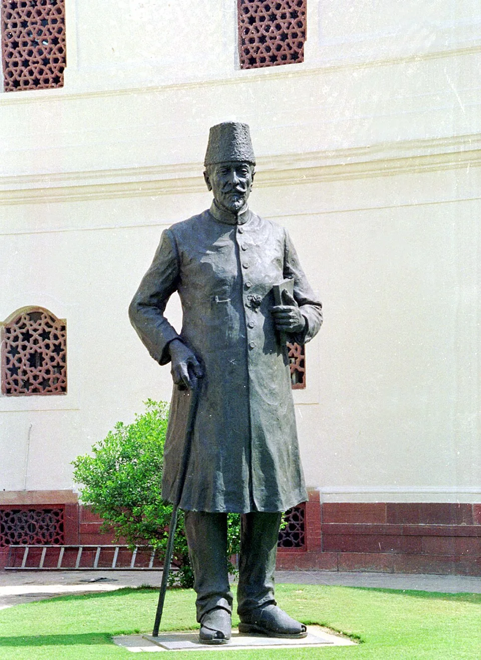Bronze statue of Maulana Abul Kalam Azad holding a book and a walking stick, standing in the Parliament complex, New Delhi.